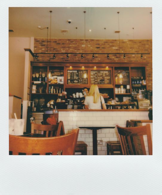 Inviting indoor scene of a contemporary coffee shop with customers and stylish decor.