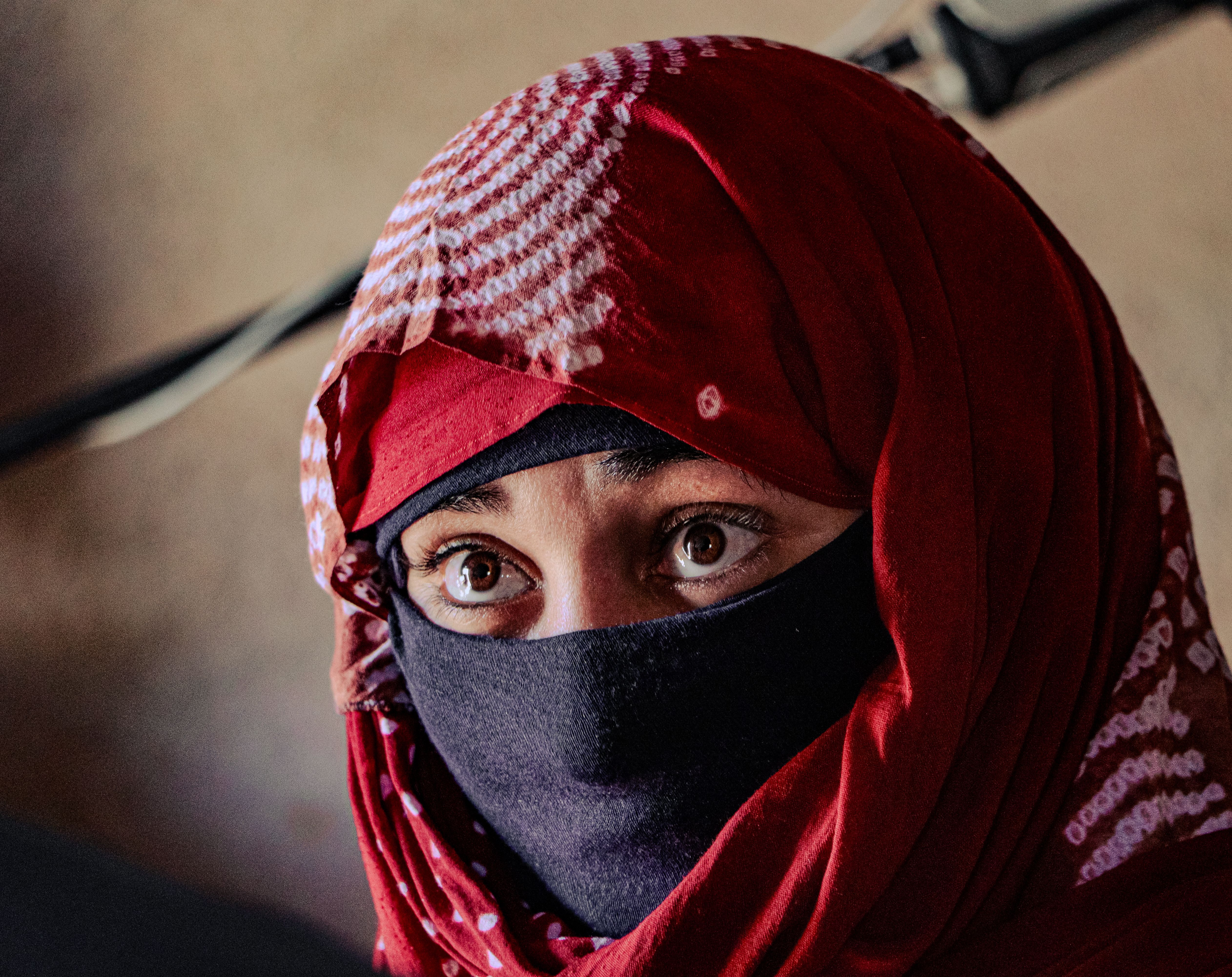 Close-up of a woman wearing a traditional hijab in Tinduf, Algeria, showcasing cultural attire.