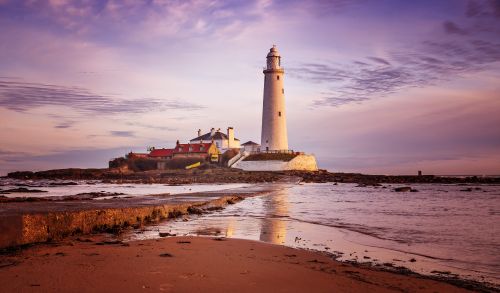 Free Captivating view of St Mary's Lighthouse at sunrise, located on a tidal island in Whitley Bay, UK. Stock Photo