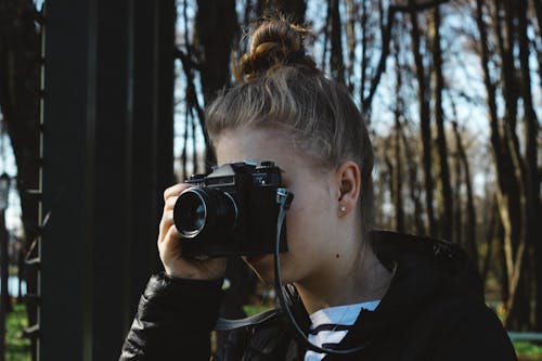 Woman Using Film Camera