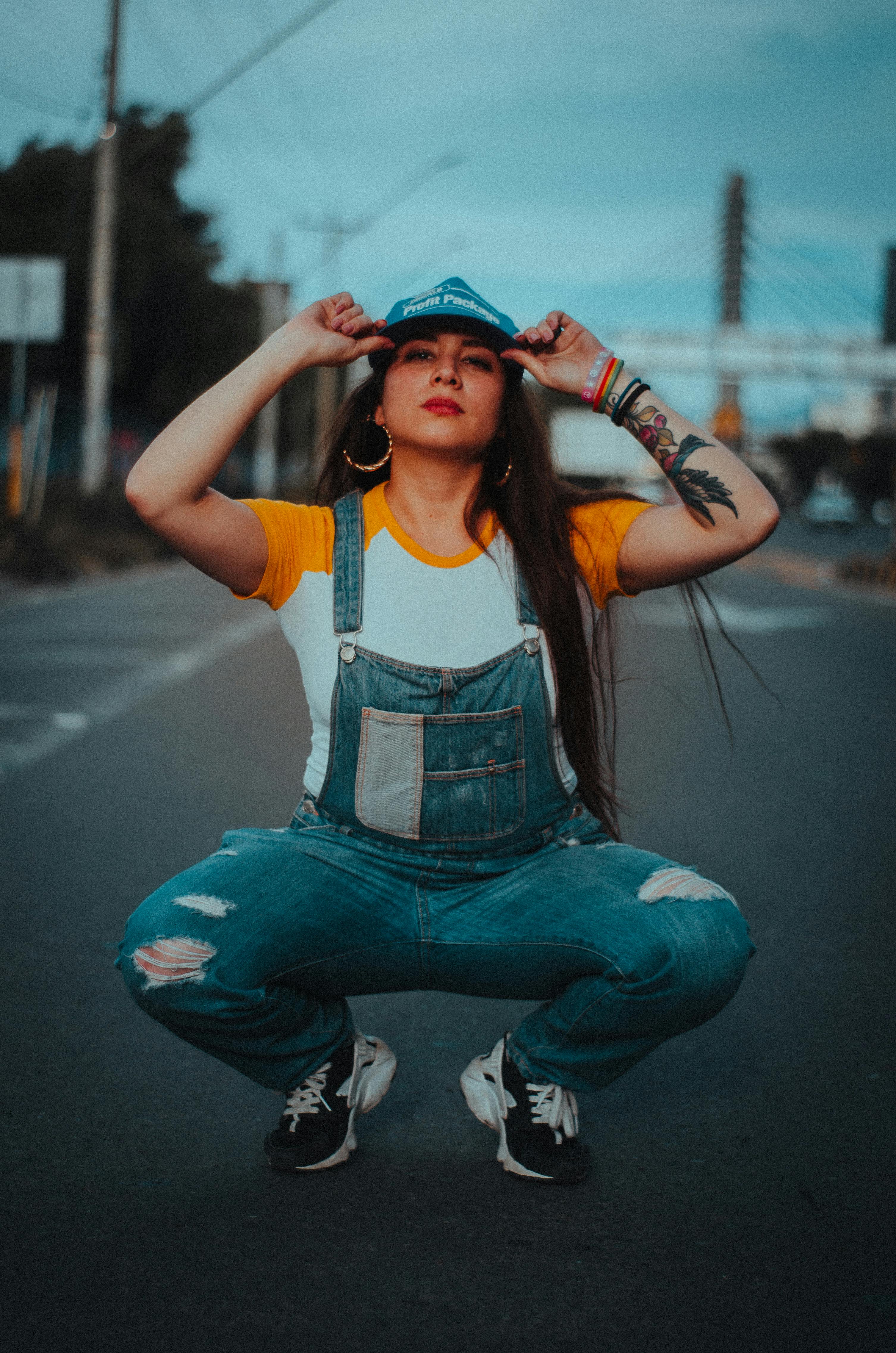 Woman Squatting on Road · Free Stock Photo