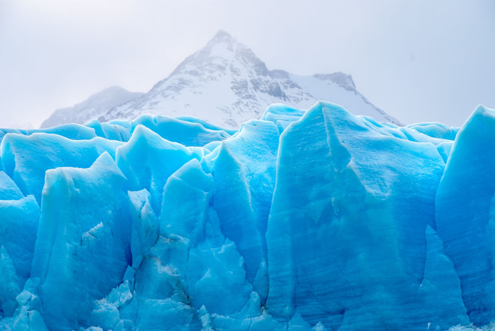 Blue Icebergs Under Cloudy Sky