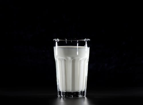Grayscale Photography of Glass of Milk