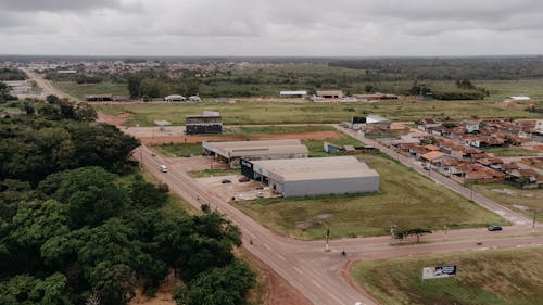 An aerial view of a rural area with a road and buildings