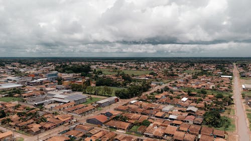 An aerial view of a city with a cloudy sky