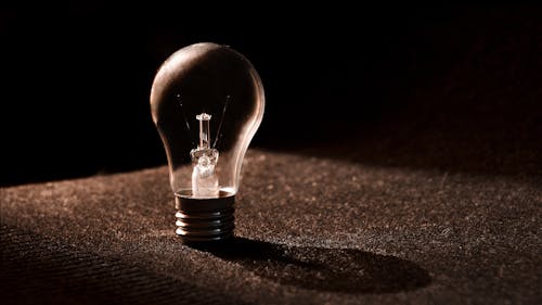 Free Clear Bulb on Brown Surface Stock Photo