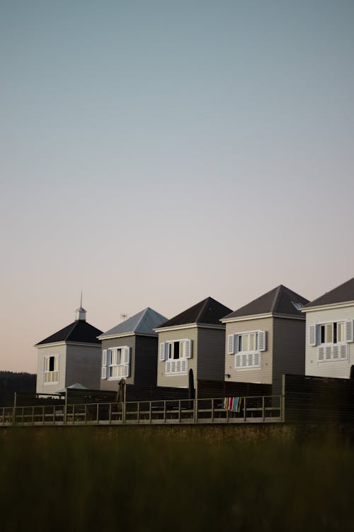 A row of houses on the beach at dusk