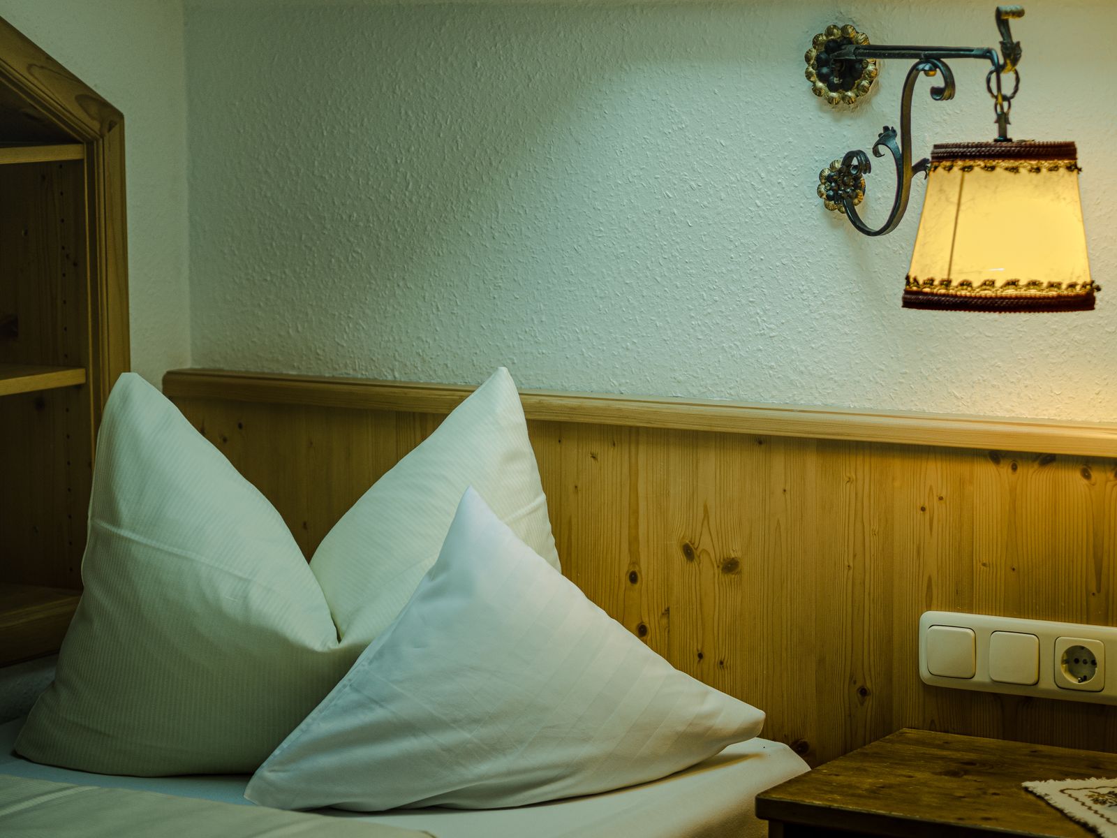 Warm bedroom with wooden headboard