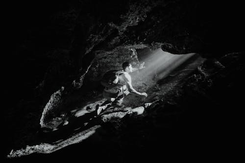 Backpacker Exploring a Cave