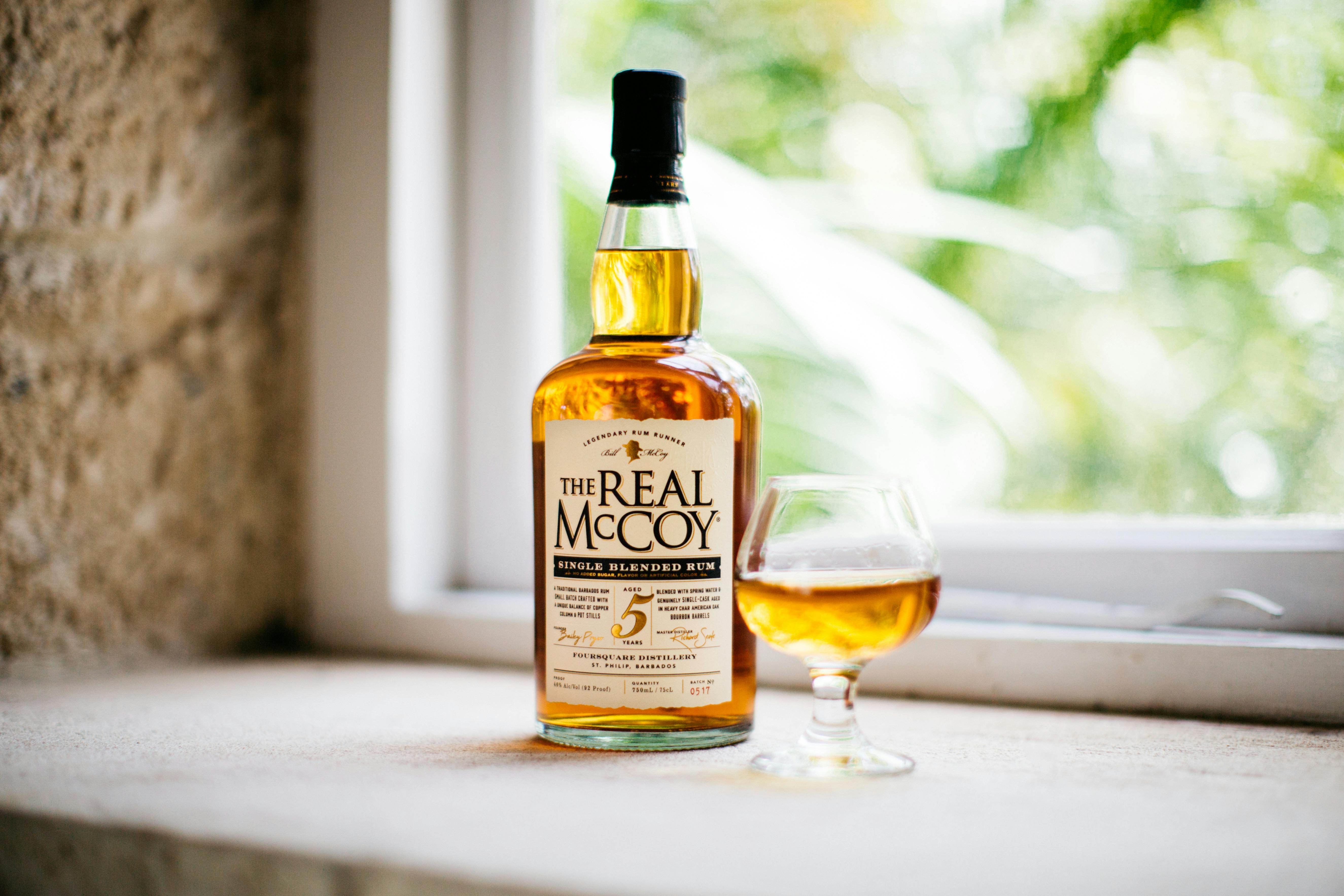 a bottle of real mccloud whiskey and a glass