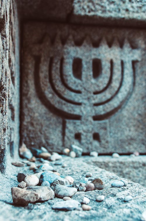 A menorah is sitting on top of a stone wall