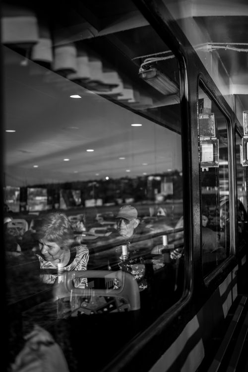 Free Passengers absorbed in thoughts reflected in train windows, creating an introspective atmosphere. Stock Photo
