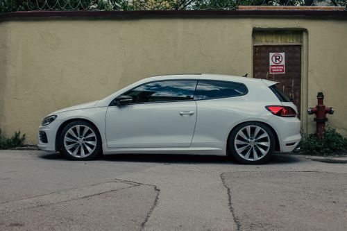 Free Side view of a white Volkswagen Scirocco parked on a street in Bursa, Türkiye. Stock Photo