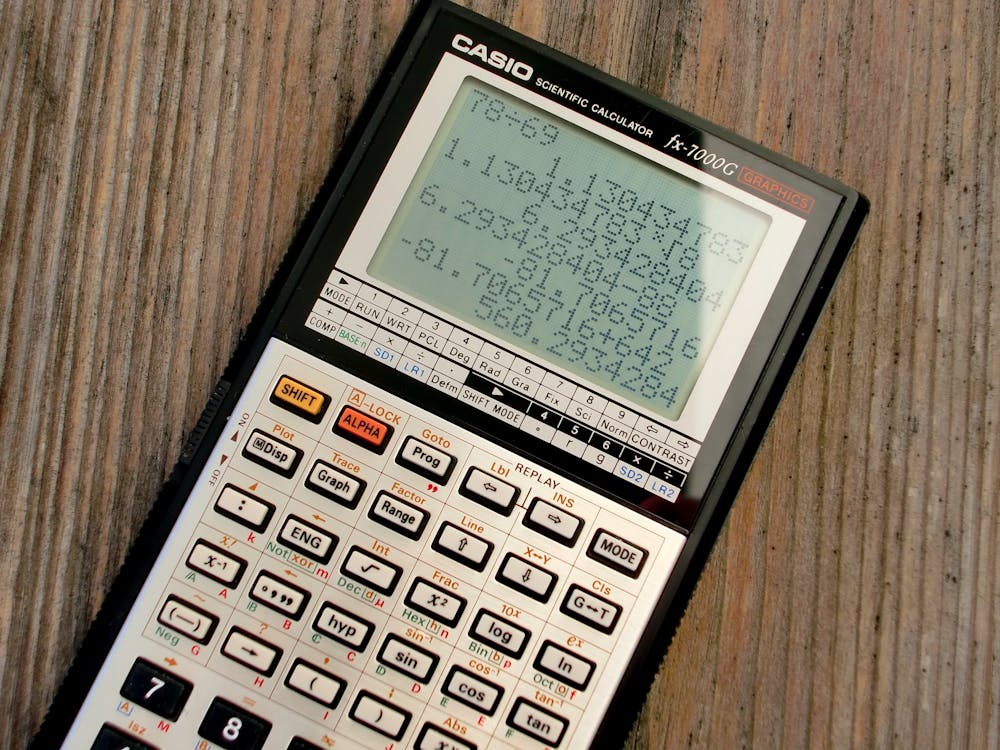 Free Scientific Calculator on Wooden Surface Stock Photo