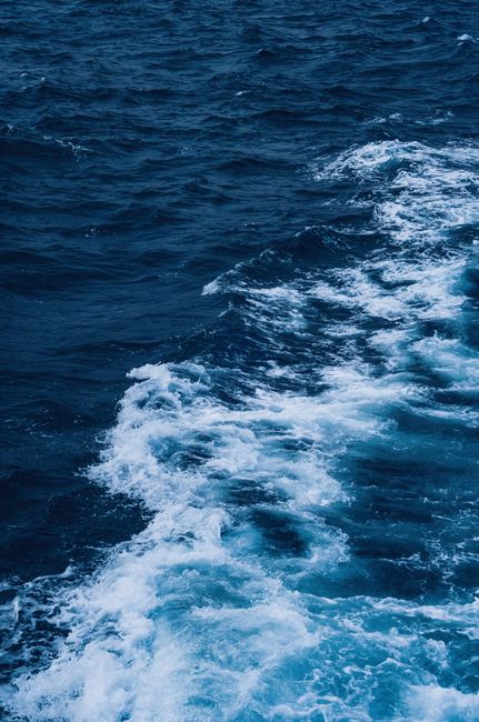 Captivating image of ocean waves crashing with white sea foam on a deep blue sea.