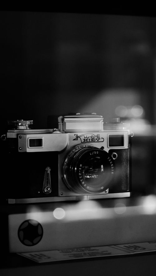 Free Classic vintage analog camera displayed elegantly in black and white tones. Stock Photo