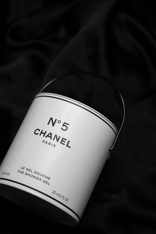 Free Elegant display of Chanel N°5 shower gel on black fabric, showcasing luxury and sophistication. Stock Photo