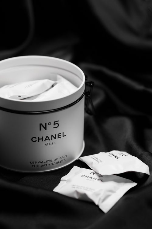 Free Chanel No.5 bath tablets elegantly displayed on black fabric, embodying luxury and sophistication. Stock Photo