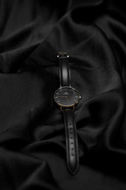 A black watch on a black satin cloth