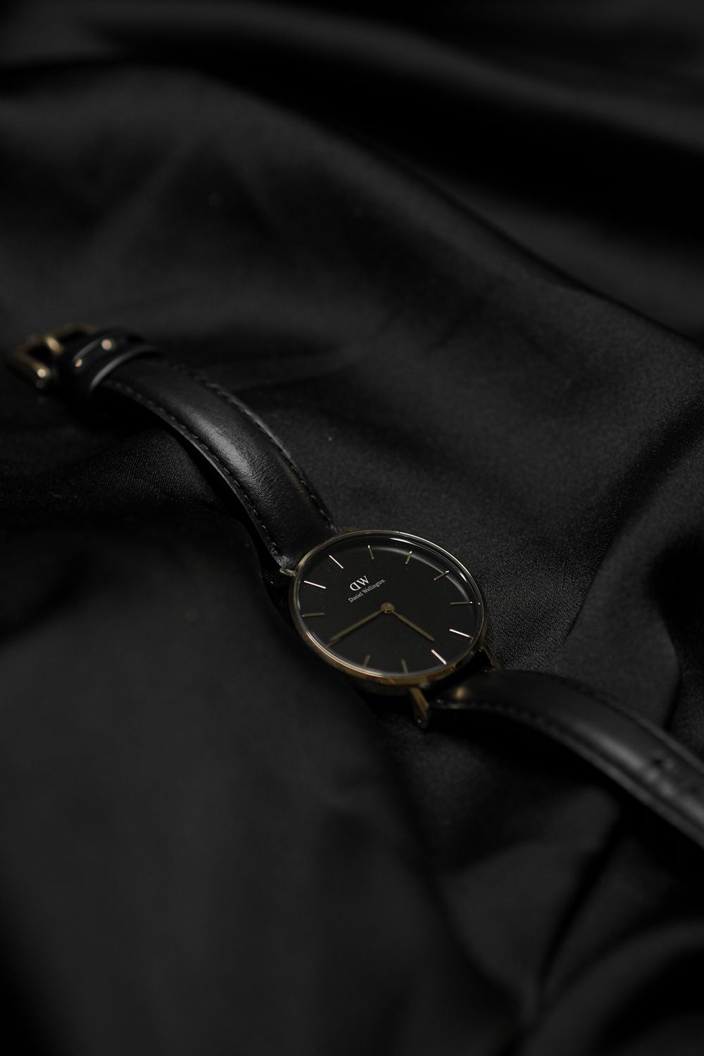 Minimal black timepiece on dark silk — Obsidian collection