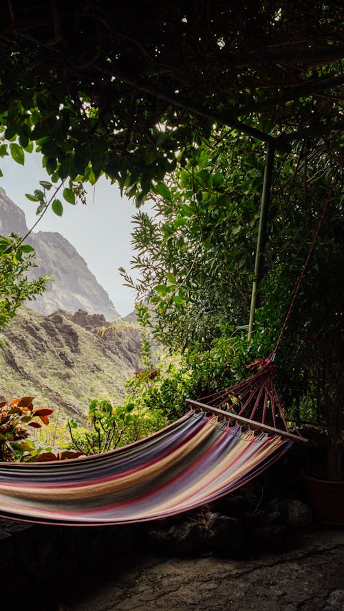 A hammock is hanging in front of a mountain