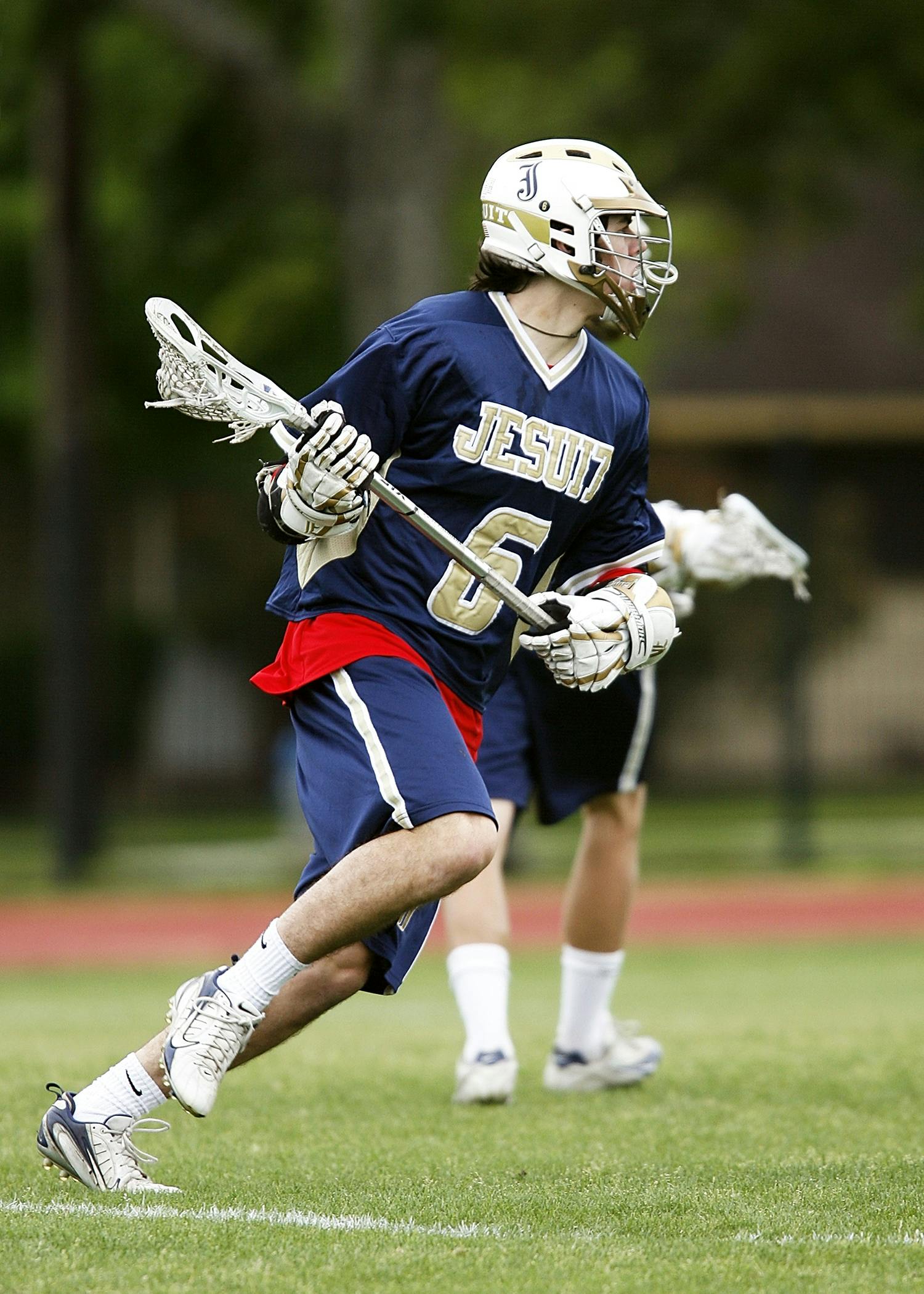 Man in Blue and White Jersey Playing Lacrosse · Free Stock Photo