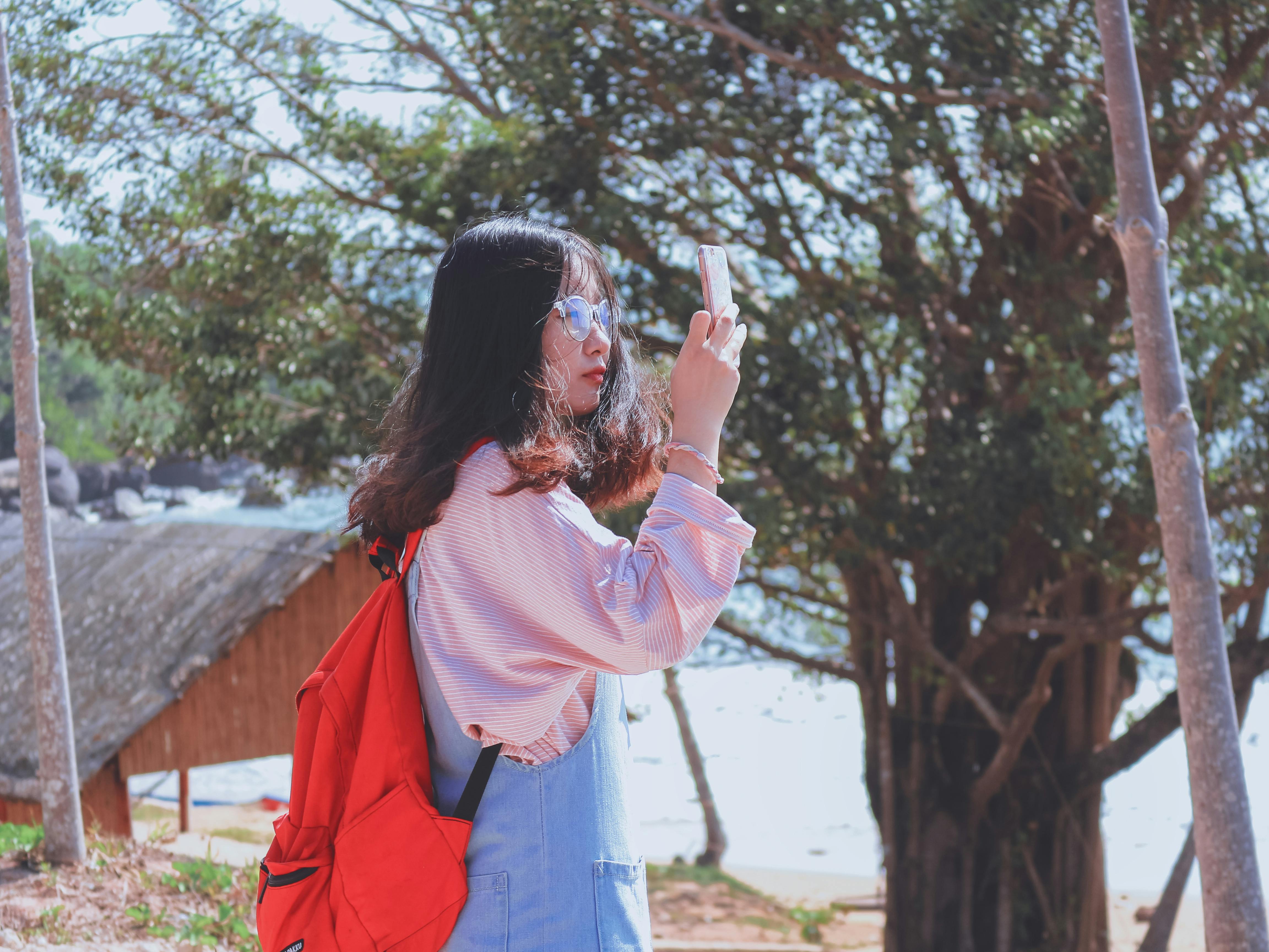 Photo of Iphone on Shirt Near Sunglasses · Free Stock Photo