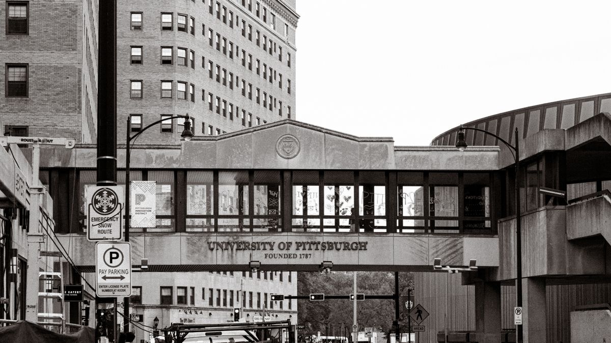 Historic University of Pittsburgh campus street view with iconic architecture in black and white. Illustrative editorial photograph.