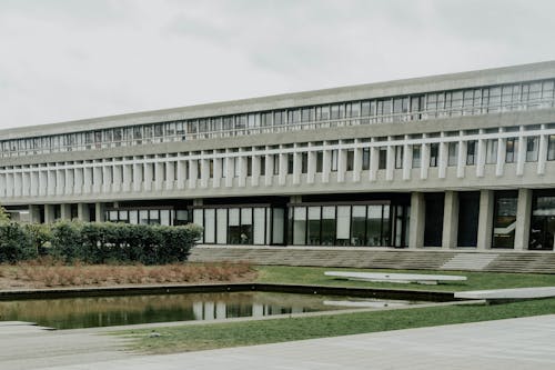 A large building with a pond in front of it