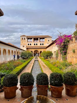 Explore the beautiful gardens of the Generalife Palace, a stunning landmark in Granada, Spain.
