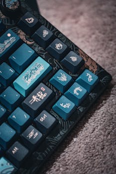 Close-up of a blue mechanical keyboard featuring unique symbols and designs on the keys.