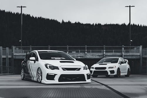 Two cars parked in front of a building