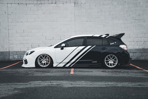 A black and white car with a white stripe on it