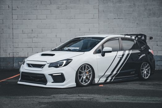 Customized Subaru WRX sports car with unique livery in an urban environment, perfect for automotive enthusiasts.