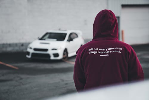 A person wearing a hoodie with the words, i'm not a car