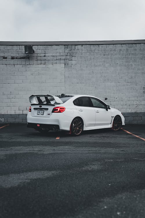 A white car parked in front of a building