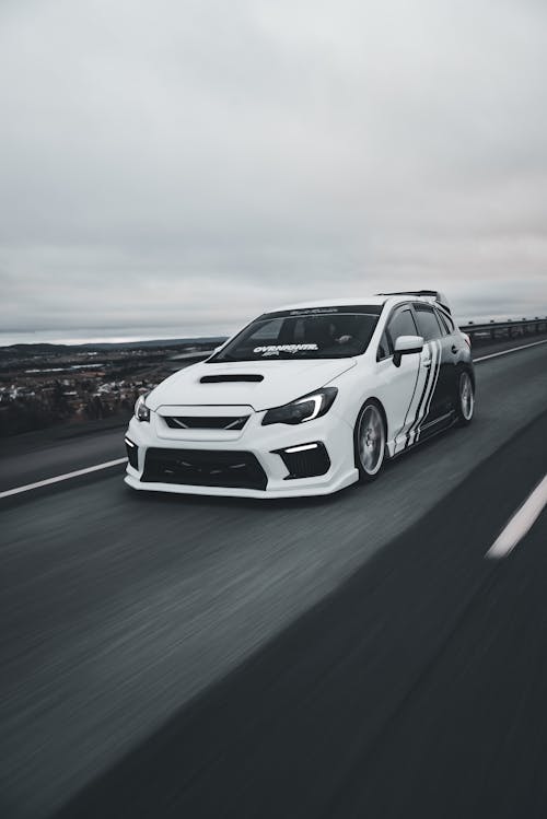 A white car driving on a road