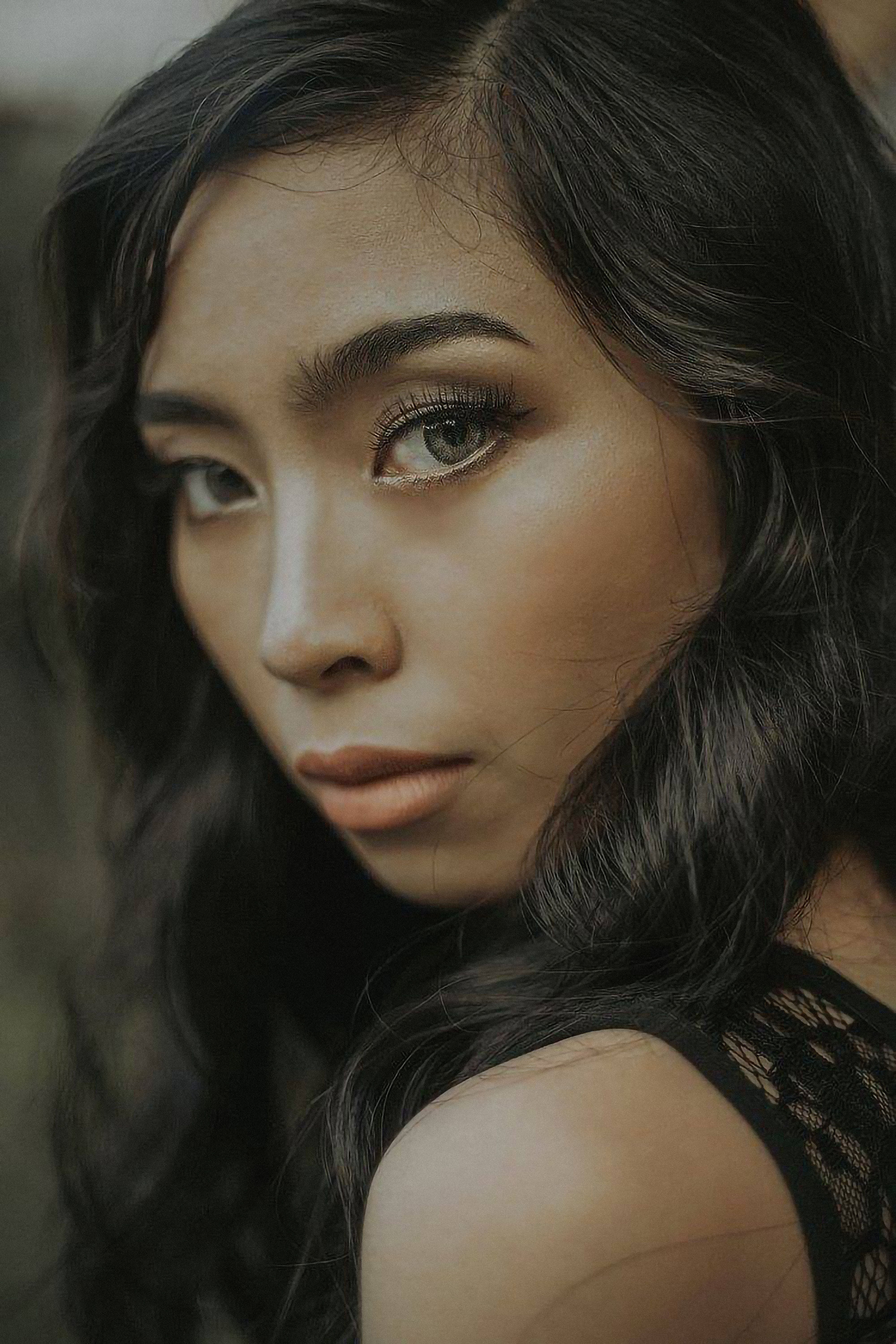 Captivating portrait of a beautiful woman with long hair gazing directly at the camera.