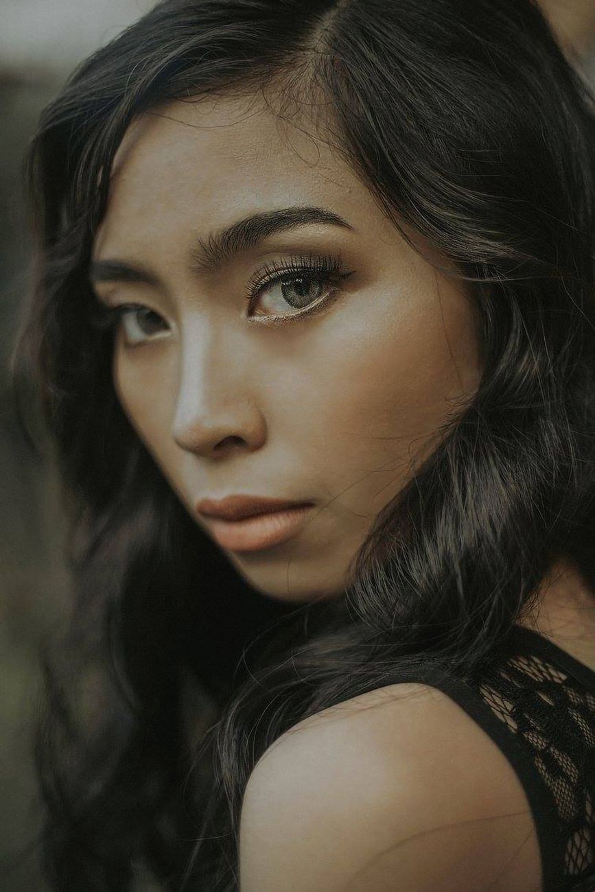 Captivating portrait of a beautiful woman with long hair gazing directly at the camera.