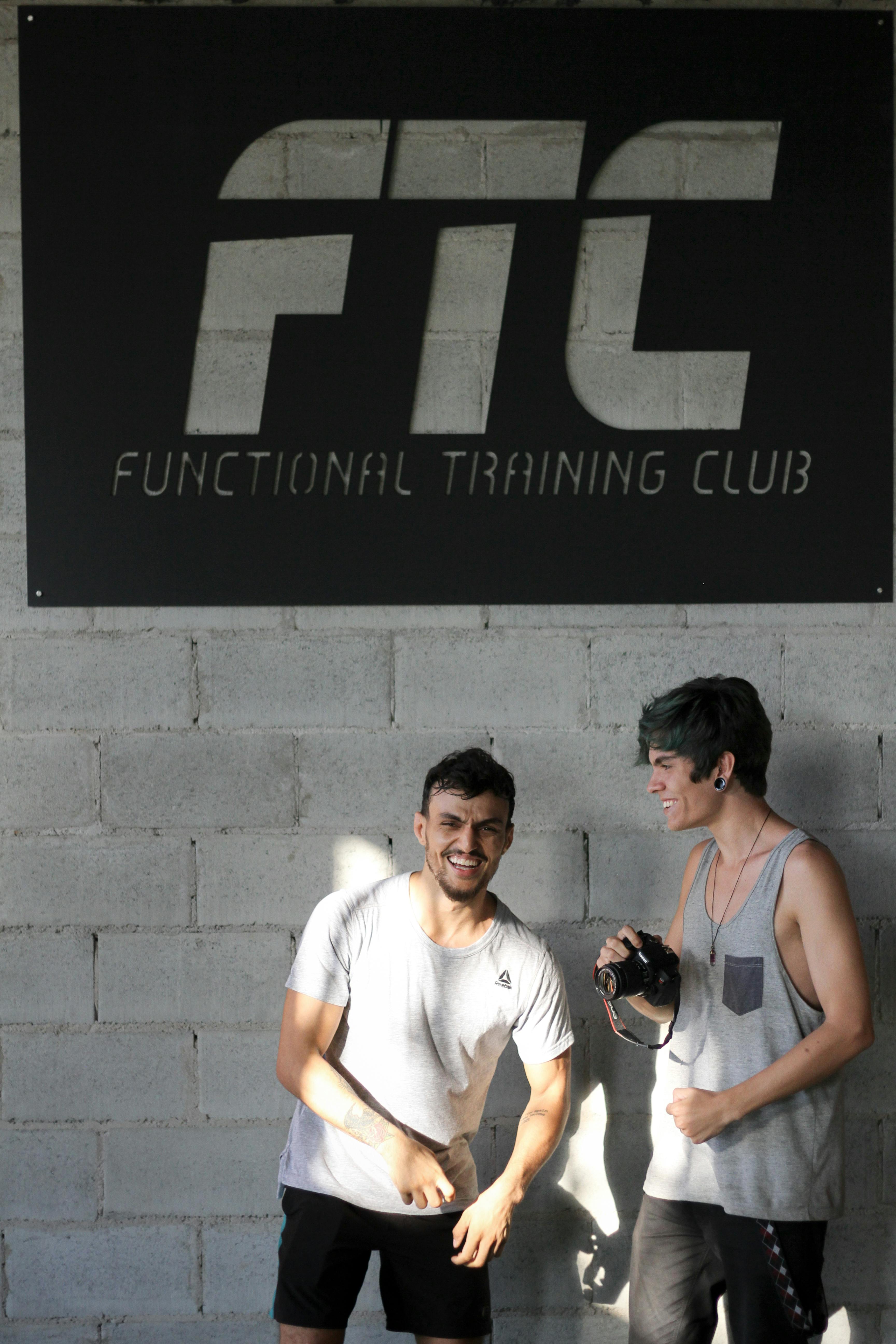 Two young men enjoying a moment at a functional training club.