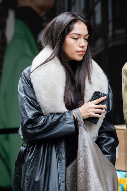 A woman in a leather jacket and fur collar