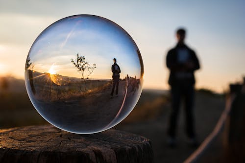 Free Forced Perspective Selective Focus Photography of Man Inside the Ball Stock Photo