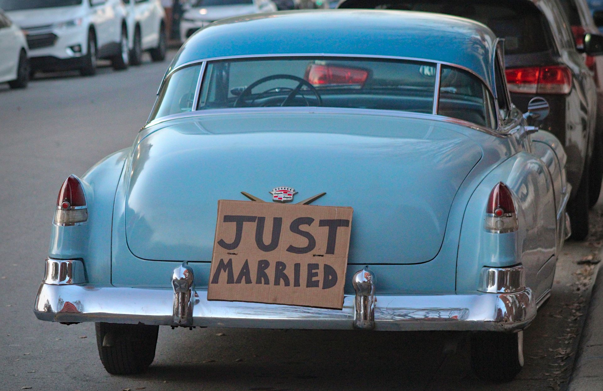 Back View of a Vintage Cadillac with a Board Saying "Just Married"