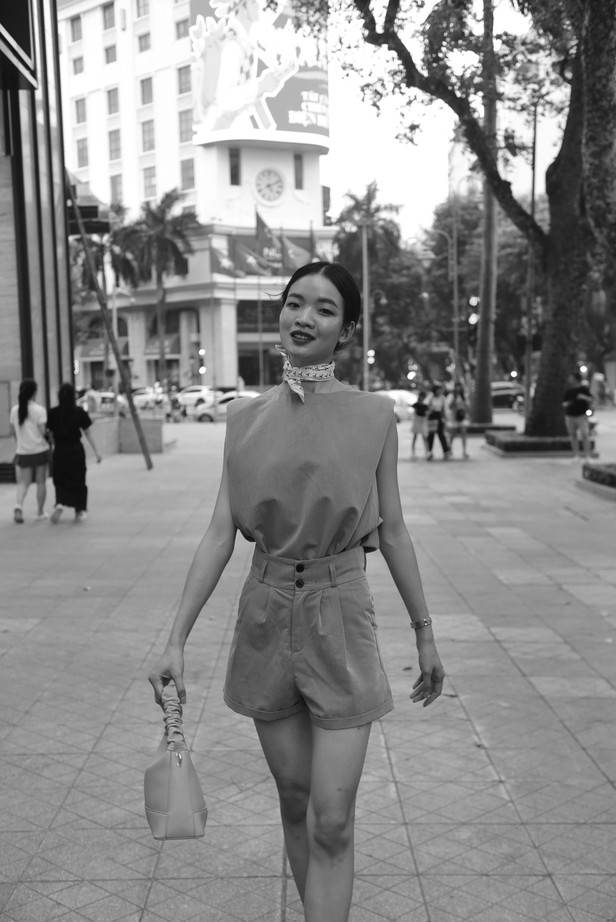 A woman in a short dress walking down the street · Free Stock Photo