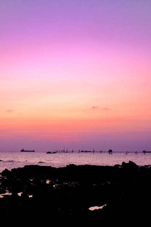 Základová fotografie zdarma na téma kotník hluboko ve vodě, modrý oceán, nádherný západ slunce