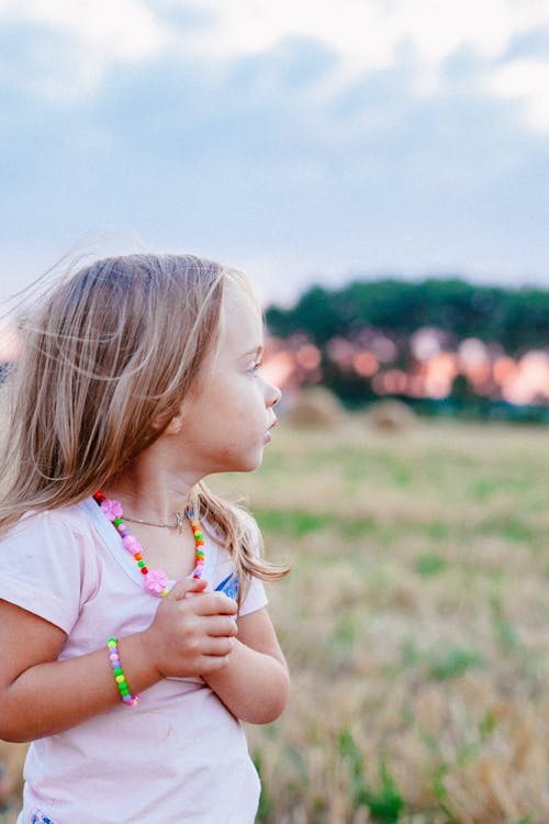 Selective Focus Photography of Girl on Grass Field