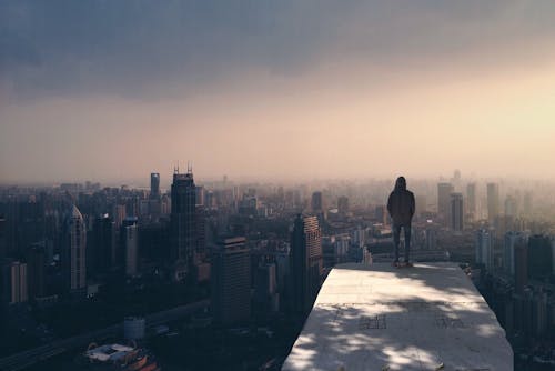 Free Man Standing on White Concrete Surface Stock Photo