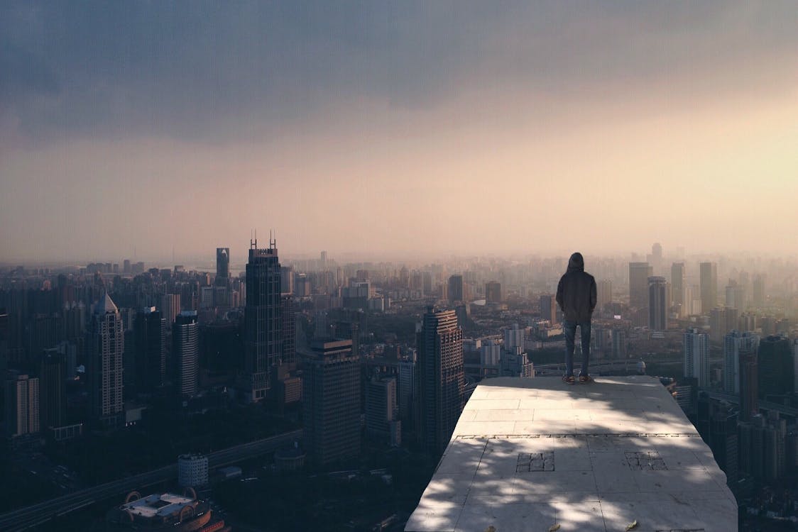 Man Standing on White Concrete Surface