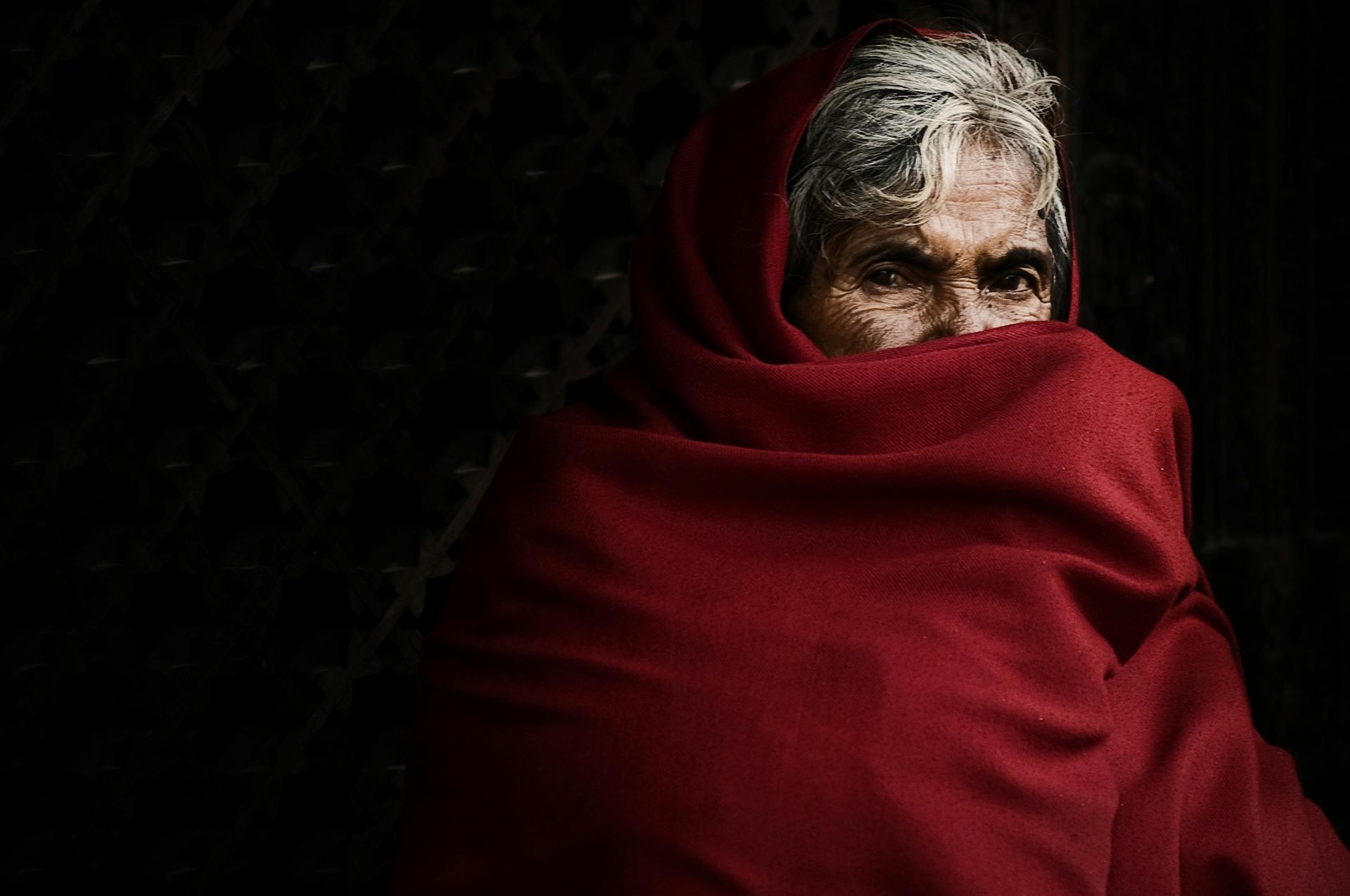 Person Covering His Face With Red Blanket