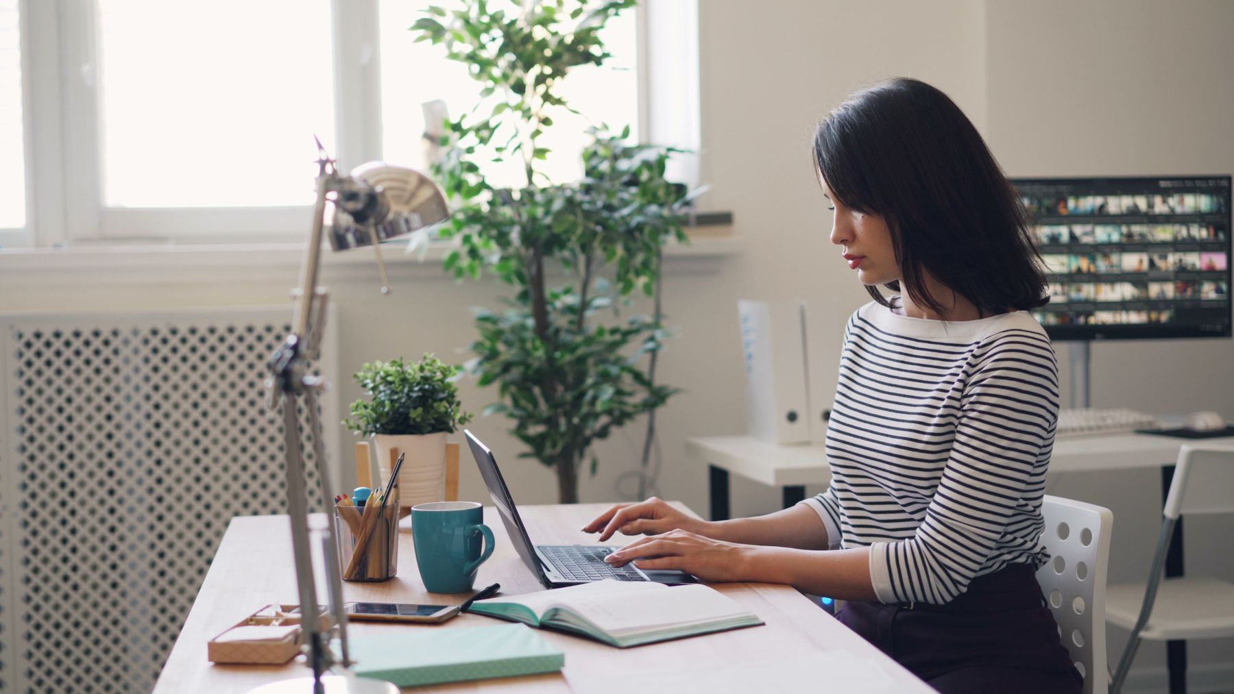 A focused business owner working from a bright office